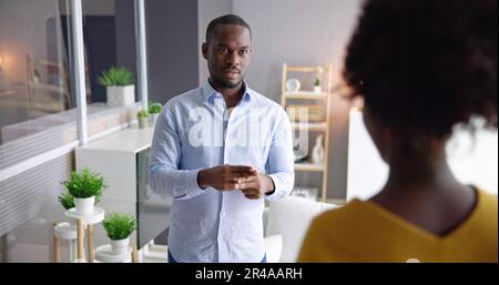 Young People Using Sign Language At Sofa Stock Photo