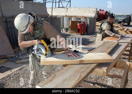 US Navy Construction Electrician 2nd Class and Builder 1st Class both assigned to Naval Mobile Construction Battalion Two Three (NMCB-23), begin construction of stairs for a Sou Stock Photo