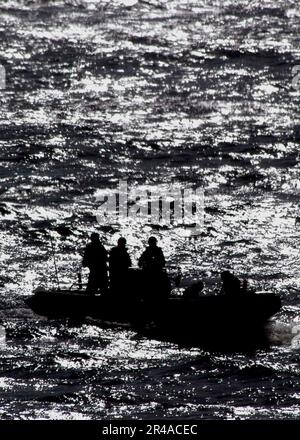 US Navy Crew members take part in a simulated man overboard recovery drill aboard USS Abraham Lincoln (CVN 72) Stock Photo