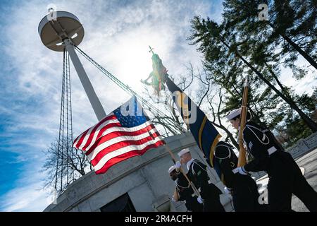 A color guard from the U.S. Navy Honor Guard supports a ceremony commemorating the 125th anniversary of the sinking of the USS Maine, Arlington National Cemetery, Arlington, Va., Feb. 15, 2023.    On Feb. 15, 1898, the USS Maine exploded off the coast of Havana, Cuba, leading to the loss of 260 of her crew. Due to Spanish policy, burials had to be made within 24 hours, therefore the initial crew recovered in the aftermath of the disaster were buried at the Colon Cemetery in Havana. On March 30, 1898, Congress approved a bill authorizing for their remains to be disinterred and transferred to AN Stock Photo