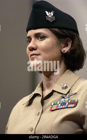 US Navy Yeoman 1st Class stands at attention as she models the khaki option of the year-round concept service uniform for Sailors E-6 and below Stock Photo