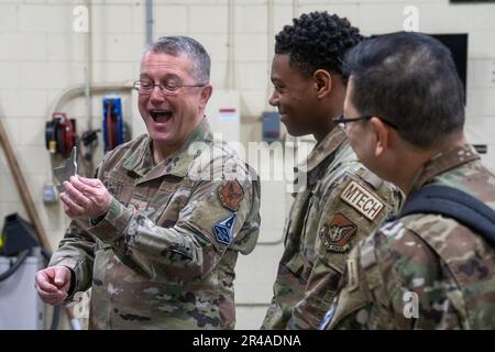 Chaplain (Maj. Gen.) Randall E. Kitchens, U.S. Air Force Chief of Chaplains, receives a metal souvenir in the shape of an F-22 Raptor from Airman 1st Class Kendrick Johnson, an aircraft metal technologies apprentice assigned to the 3rd Maintenance Squadron, on Joint Base Elmendorf-Richardson, Alaska, Jan. 20, 2023. Kitchen’s souvenir was made using a water jet cutter, a machine that allows Airmen from the 3rd MXS to cut pieces of metal with high precision, creating essential parts for the aircraft on JBER. Stock Photo