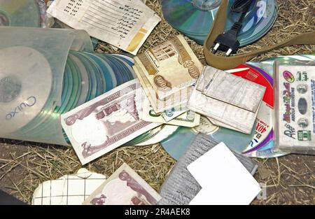 US Navy A young Iraqi boy lead U.S. Army Soldiers to a cache of money, CD-ROMS, wiring, car remotes and an AK-47 assault rifle with five magazines in the city of Baghdad, Iraq Stock Photo