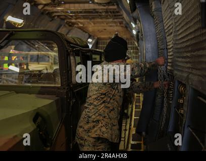 U.S. Marines with 1st Battalion, 10th Marine Regiment, 2d Marine Division prepare to disembark tactical vehicles during exercise Rolling Thunder on Fort Drum, New York, March 24, 2023. This exercise is a live-fire artillery event that tested the 10th Marine Regiment’s ability to operate in a simulated littoral environment against a peer threat in a dynamic and multi-domain scenario. Stock Photo