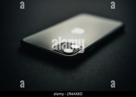 A close-up of an iPhone with the Apple logo on the back Stock Photo
