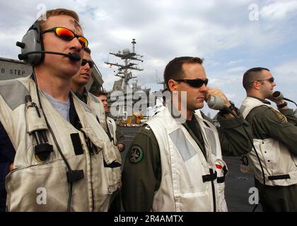 US Navy Landing Signal Officers (LSO) observe aircraft recovery operations aboard the Nimitz-class aircraft carrier USS Harry S. Truman (CVN 75) Stock Photo