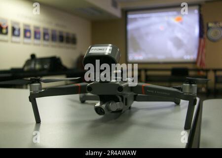 A close-up aerial view of a modern drone on a wooden table in a contemporary living room Stock Photo
