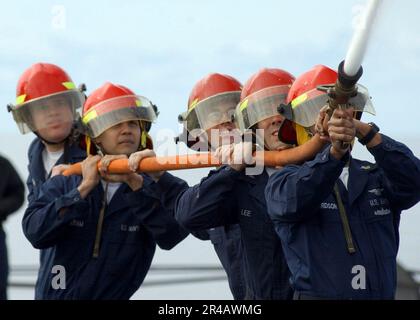 US Navy  Sailors assigned to a repair locker fire party participated in a hose-handling event during the Damage Control Olympics. Stock Photo