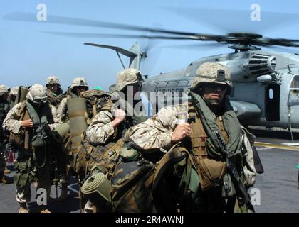 US Navy  U.S. Marines assigned to the 26th Marine Expeditionary Unit exit a CH-53E Super Stallion helicopter and transit the flight deck aboard the amphibious assault ship USS Kearsarge (LHD 3). Stock Photo