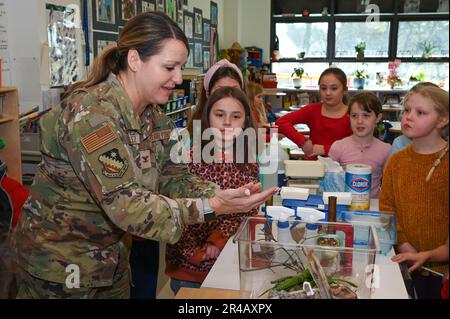 Col. Taona Enriquez, installation commander, holds a Praying Mantis while visiting the Hanscom Primary School at Hanscom Air Force Base, Mass., Jan. 27, while HPS students look on. Enriquez and Command Chief Master Sgt. Alan Weary toured the facility and met with staff and students to learn more about the school. Stock Photo