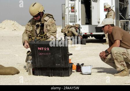 US Navy  Hull Maintenance Technician 2nd Class left, assembles demolition charges as Chief Electronics Technician Richard Straney supervises to ensure the proper procedure is followed. Stock Photo