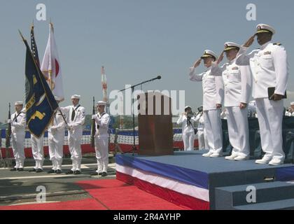 US Navy  Commander, Carrier Group Five, Rear Adm. James D. Kelly, center, Cmdr. and Lt. render honors during the playing of the American and Japanese National Anthems. Stock Photo