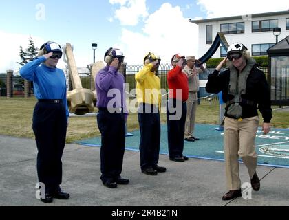 US Navy Vice Adm. Gerry Hoewing and his wife are rendered honors as ...