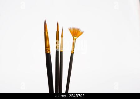 Close-up of brushes of different sizes isolated on a white background Stock Photo