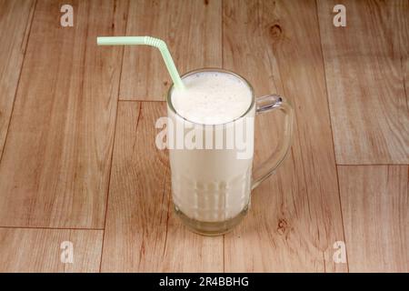 chill lassi in glass on wooden background. indian drink. Stock Photo