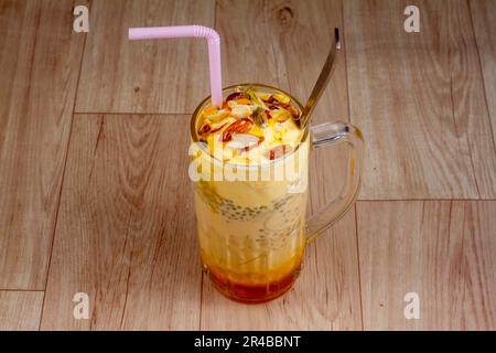 chill mango Falooda in glass on wooden background Stock Photo