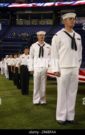 US Navy  Sailors, Sea Cadets and Junior ROTC students from the Twin Cities hold a ceremonial flag during pre-game ceremonies. Stock Photo