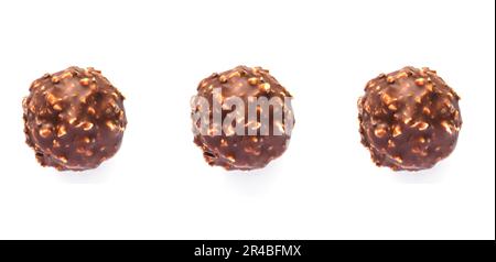 Three tasty chocolate candies isolated on white background, close-up Stock Photo