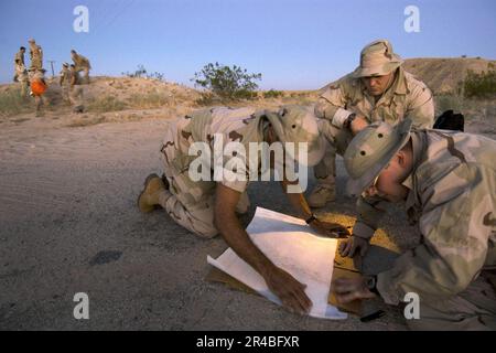 US Navy  Joint service instructors teach desert evasion, shelter construction, water procurement and night navigation. The four-day course puts students into a hostile scenario in the desert near Naval Air Fie. Stock Photo