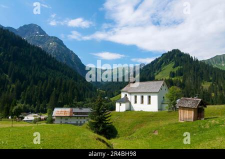 Chapel in Baad, Kleinwalsertal with Widderstein, Vorarlberg, Austria Stock Photo