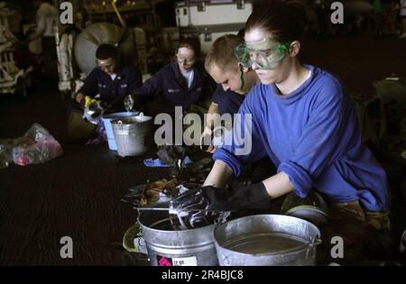 US Navy  Crew members sanitize MCU-2P gas masks in the hangar bay aboard the nuclear-powered aircraft carrier USS Nimitz (CVN 68). Stock Photo