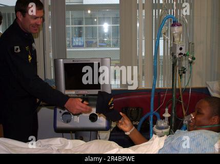 US Navy  A member of the U.S. Navy Parachute Team, the Leap Frogs visits with a patient at the Children's Hospital of Philadelphia. Stock Photo