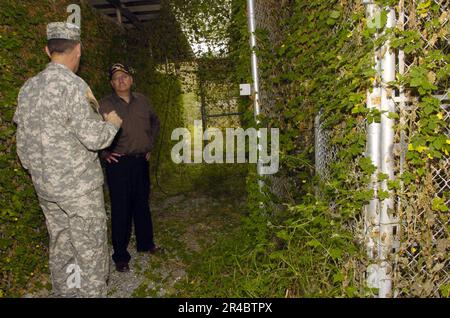 US Navy  Led by Joint Task Force Guantanamo Commanding General, Maj. Gen. Jay Hood, Secretary of the Navy (SECNAV), Dr. Donald C. Winter, inspects the heavily overgrown remains of Camp X-ray. Stock Photo