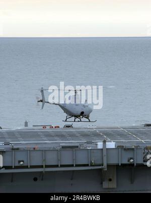 US Navy  A RQ-8A Fire Scout Vertical Takeoff and Landing Tactical Unmanned Aerial Vehicle (VTUAV) System prepares for the first autonomous landing aboard the amphibious transport dock ship USS Nashville (LPD 1. Stock Photo