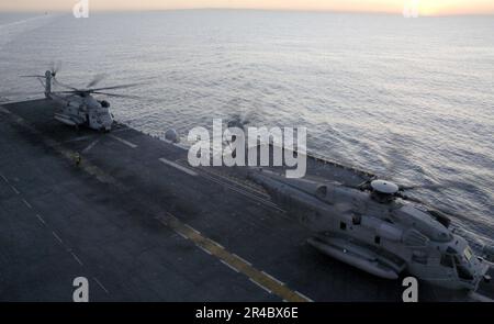 US Navy  Two CH-53E Super Stallion helicopters, assigned to the Sea Elks of Marine Medium Helicopter Squadron One Six Six (HMM-166) prepare for lift off from the flight deck. Stock Photo