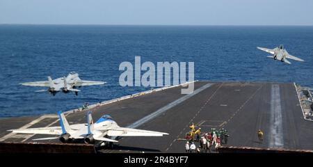 US Navy  Two F-14D Tomcats launch from the flight deck of the Nimitz-class aircraft carrier USS Theodore Roosevelt (CVN 71). Stock Photo