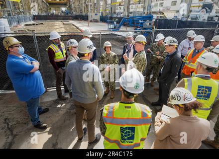 The Honorable Erik Raven, Under Secretary of the Navy; Adm. Lisa Franchetti, Vice Chief of Naval Operations; and Rear Adm. Dean VanderLey, commander, Naval Facilities Engineering Systems Command, discuss ongoing construction work in the Machine Shop, Building 431, at Puget Sound Naval Shipyard & Intermediate Maintenance Facility in Bremerton, Washington, March 29, 2023. Stock Photo