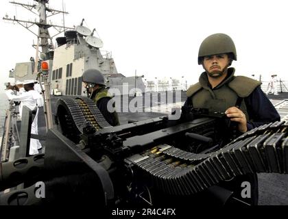 US Navy  Gunner's Mate Seaman mans an M2HB twin .50 Caliber Machine Gun. Stock Photo