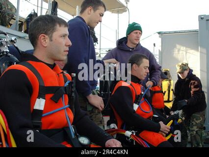 US Navy  Master Diver pre-screening candidates focus on upcoming missions in the training brief aboard Landing Craft Unit (LCU-1647) at Naval Amphibious Base Little Creek. Stock Photo