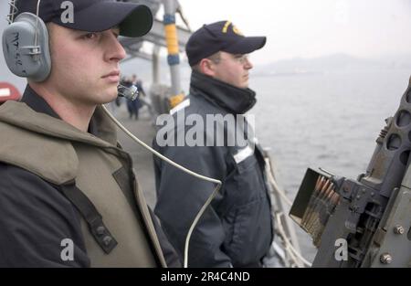 US Navy  Gunner's Mate Seaman stands force protection watch with Fire Controlman 2nd Class Stock Photo