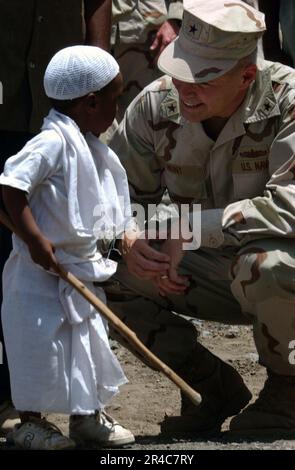 US Navy  Commander of Combined Joint Task Force Horn of Africa, Rear Adm. Richard W. Hunt, visits with the 4-year old grandson of the Sultan of Tadjoura, Abdoulaker Moumat Houmed. Stock Photo