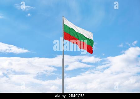 Flag of Bulgaria is waving in front of blue sky and clouds Stock Photo