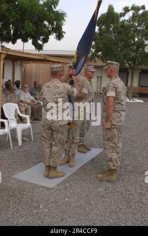 US Navy  U.S. Marine Corps Lt. Gen. John Sattler hands over the U.S. Navy flag to Navy Capt. officially transferring command of Camp Lemonier to the U.S. Navy. Stock Photo