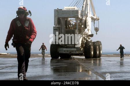 Members of the Crash and Salvage Division move the aircraft crash crane ...