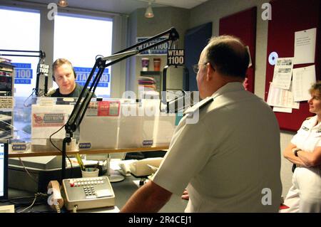 US Navy  Chief of Naval Personnel Vice Adm. John C. Harvey Jr. is interviewed by popular radio host Bill Wills for a segment on WTAM 1100AM's morning talk show. Stock Photo
