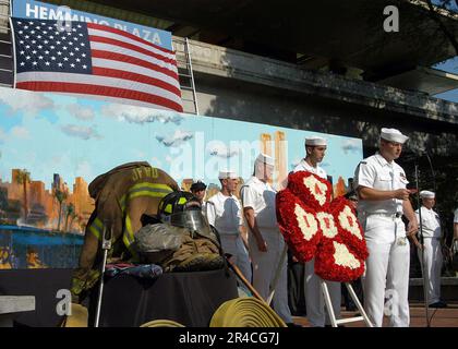 US Navy  Sailors from USS John F. Kennedy (CV 67) read names of New York Fire and Police Department members who lost their lives during the terrorist attacks. Stock Photo