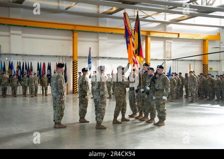 12th Combat Aviation Brigade (12 CAB), Soldiers, Family and members of the Ansbach community, gathered for the Change of Responsibility Ceremony for the outgoing Command Sergeant Major, Command Sgt. Maj. Zane B. Hansen to the incoming Command Sergeant Major, Command Sgt. Maj. Kyle P. Clutter. The ceremony took place in Hangar 2 on the Katterbach Airfield, Ansbach, Germany, Feb. 16, 2023. Stock Photo