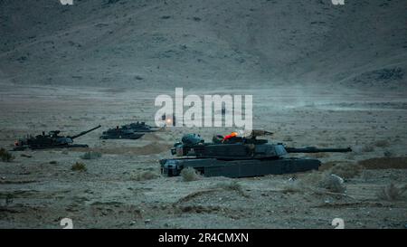 U.S. Army Soldiers assigned to the 'Hound Battalion,' 3rd Battalion, 67th Armored Regiment, 2nd Armored Brigade Combat Team, 3rd Infantry Division, form a defensive line with modernized M1A2 SEPv3 Abrams tanks at the National Training Center, Fort Irwin, California, March 10, 2023. The Spartan Brigade, the Army’s most modernized brigade, completed its rotation NTC 23-05, making it not only the best equipped but most lethal unit in America’s arsenal as the Army moves toward building the Army of 2030. Stock Photo