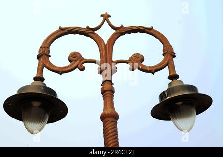 Old vintage street lamp on the road at night. Old vintage streetlight on on park Stock Photo
