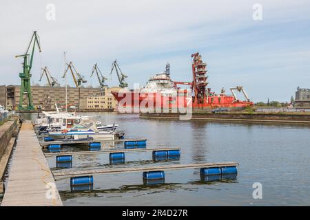 Gdansk, Imperial Shipyard, Poland - 01 May 2019: Ship moored at the quay of the shipyard. Cranes in the background. Stock Photo