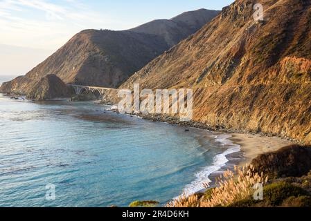 Bridge on a the Pacific coast highway 1 running along the rugged coast of California at sunset in autumn Stock Photo