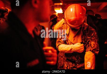 Recruits participate in Battle Stations inside USS Trayer (BST 21) at Recruit Training Command (RTC). Trayer, more commonly referred to as 'Battle Stations,' is the crucible event that recruits must pass prior to graduation, testing their knowledge and skills in basic seamanship, damage control, firefighting and emergency response procedures. Boot camp is approximately 10 weeks and all enlistees into the U.S. Navy begin their careers at the command. Training includes five warfighting competencies of firefighting, damage control, seamanship, watchstanding, and small arms handling and marksmansh Stock Photo