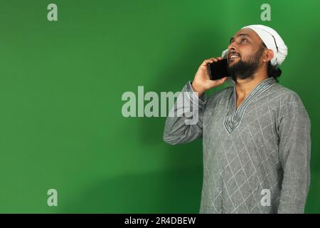Young Indian Farmer Talking To Someone On His Mobile, Green Screen, Copy Space Stock Photo