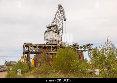 Gdansk, Imperial Shipyard, Poland - 01 May 2019: Milk Peter, an art gallery in the Imperial Shipyard. Old crane in the foreground. Stock Photo