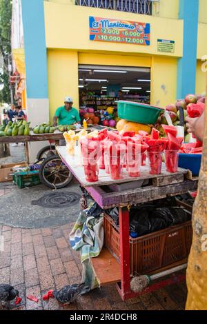 Carts are set up on a street in Cartagena Colombia selling watermelon and other fruits Stock Photo