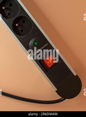 Multiple socket with switch on pastel pink background Stock Photo
